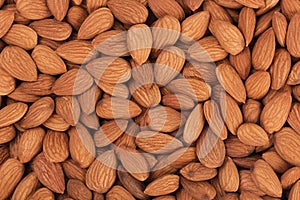 Pile of almonds close-up as background.