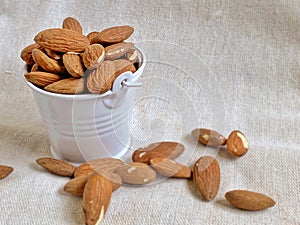 A pile of almonds in a tiny pail background. Healthy  Eating Concept.