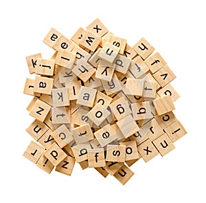 Pile of alphabet letters on wooden scrabble pieces, isolated on white background with clipping path photo