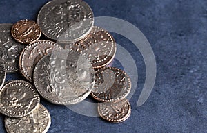 Pile of Ancient Roman Coin Replicas on a Blue Background