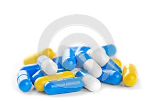 Pile of antibiotic color pills on a white background