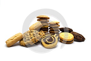 Pile of assorted cookies. Chocolate chip, oatmeal, raisin, Danish cookies and biscuits in the shape of a spiral pattern isolated o