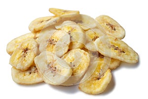 A pile of banana chips on white background, isolated. Dried banana pieces