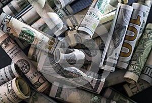 Pile of banknotes of American dollar bills of various denominations as a symbol of wealth and stability