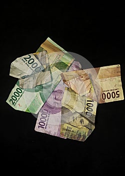 Pile of banknotes. Rupiah currency isolated on a black background.