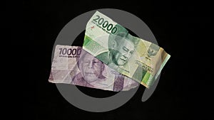 Pile of banknotes. Rupiah currency isolated on a black background.