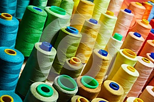 Pile of big colorful spools of thread.