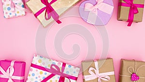 Pile of birthday gifts appear on bottom and top of pink theme. Stop motion