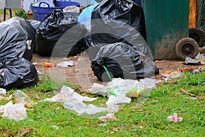 Pile black garbage bag roadside in the city close up