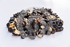Pile of black walnuts isolated on white background.