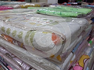 A pile of blanket in kidswear and baby needs store