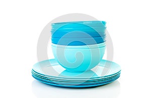 Pile of blue plastic plates and bowls