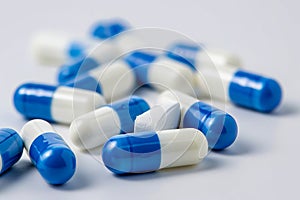 A pile of blue and white pills on a white surface