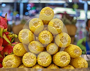 Pile of boiled corns in the store. Food background