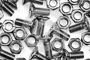 Pile of a bolts and screws on white.