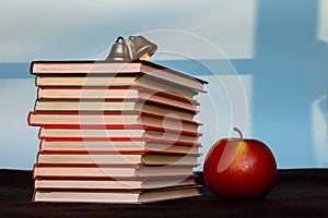 Pile of books with apple, education, reading, back to school concept, copy space text