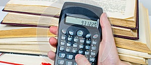 Pile of books and calculator