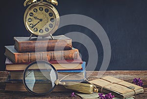 Pile of books with clock