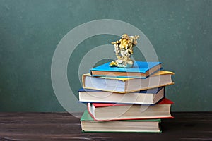 Pile of books in color covers and a netsuke (Pile of books in co