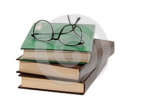 Pile of books and eyeglasses