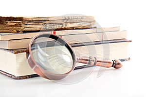 A pile of books and magnifiers on a white background