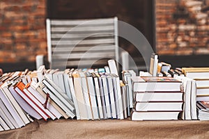 Pile of books on table outdoor. Abstract blurred background . Education, school, study, reading literature