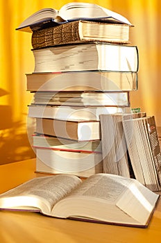 A pile of books on a wooden table
