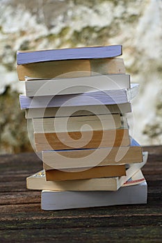 A pile of books on a wooden table