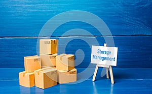 Pile of boxes and storage management easel. A set of measures for the effective organization of storage of goods in the warehouse