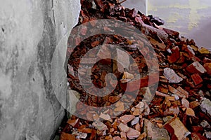 pile of bricks lying around, ruined wall in abandoned building, shelter, concept of destruction of buildings from bombing,