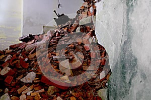 pile of bricks lying around, ruined wall in abandoned building, shelter, concept of destruction of buildings from bombing,