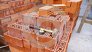 A pile of bricks with tools on it at the construction site