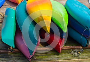 Pile Colorful Kayaks