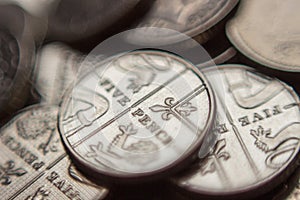 Pile of British 5 pence coins