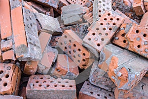 A pile of broken bricks after the demolition of a building. Landfill of old building material after structural failure