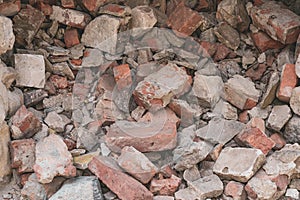 Pile of broken bricks. Grunge background. Red brick. Antique texture. Danger of destruction building.