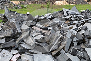 Pile of broken granite stones. Many pieces of broken stone. Wastes from the production of granite products