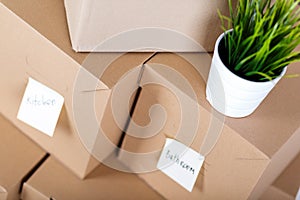 Pile of brown cardboard boxes with house or office goods