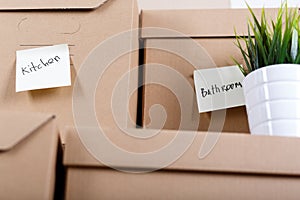 Pile of brown cardboard boxes with house or office goods.