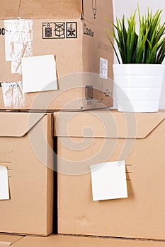 Pile of brown cardboard boxes with house or office goods