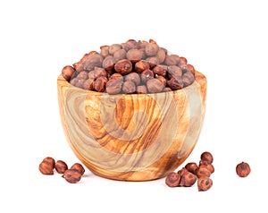 Pile of brown chickpeas in olive bowl, isolated on white background. Brown chickpea. Garbanzo, bengal gram or chick pea