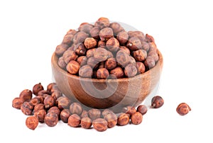 Pile of brown chickpeas in wooden bowl, isolated on white background. Brown chickpea. Garbanzo, bengal gram or chick pea