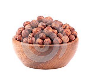 Pile of brown chickpeas in wooden bowl, isolated on white background. Brown chickpea. Garbanzo, bengal gram or chick pea