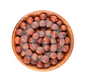 Pile of brown chickpeas in wooden bowl, isolated on white background. Brown chickpea. Garbanzo, bengal gram or chick pea