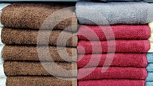 Pile of brown, red, light blue Towel at factory outlet