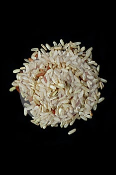 Pile of brown rice isolated on Black Background