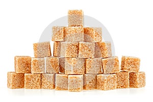 Pile of brown sugar cubes isolated on white background. Pieces of cane sugar