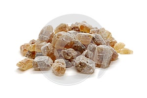 Pile of brown sugar pieces isolated on white background