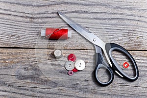 Pile of buttons, scissors, thimble, bobbin of thread