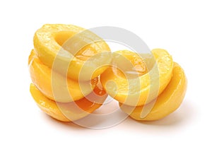 Pile of canned peach fruit`s halves